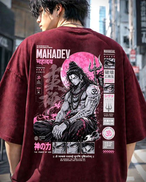 A man viewed from behind wearing an oversized maroon t-shirt with a large pink and black graphic print of a seated figure and text, set against a blurred city street background.